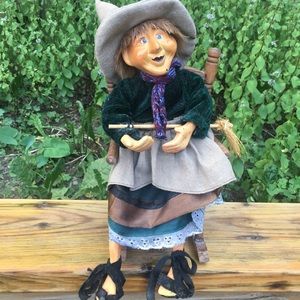 Witch doll sitting on a chair